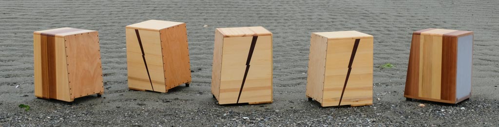 Five cajons with resonant heads on a beach