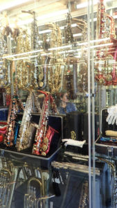 Saxophones in a glass case for sale